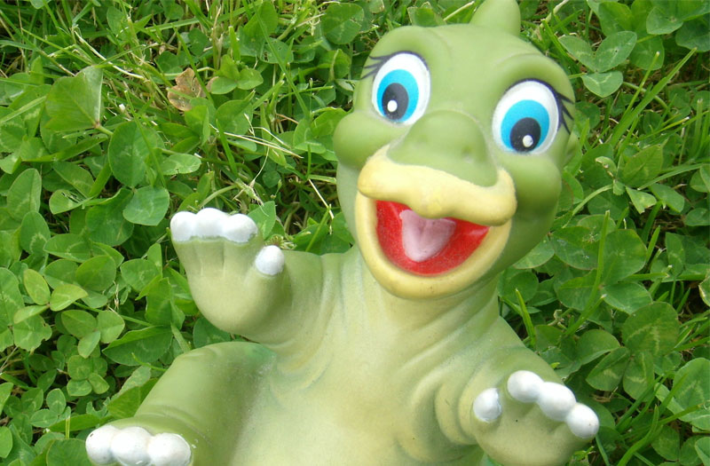 Picture of a toy dinosaur with a happy smile. It's a rogetsthesarus... get it?