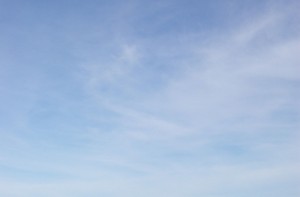 Wispy white clouds against a blue sky