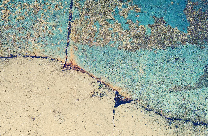 Close-up image of artfully cracked and distressed concrete